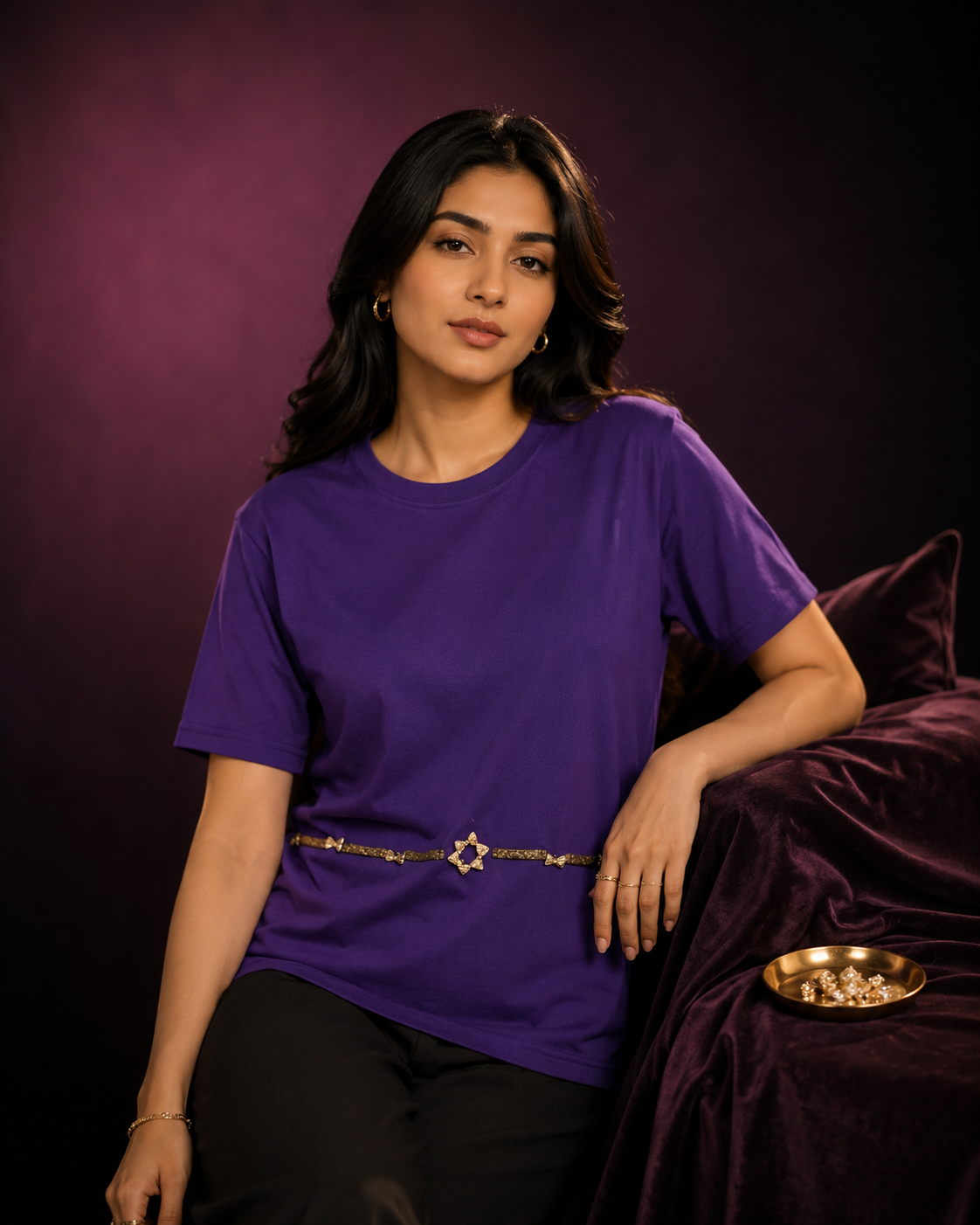 AI-generated editorial photoshoot for IZZ Habitus, purple tee with star belt against a wine backdrop, velvet chaise