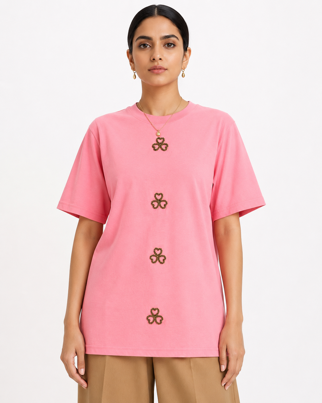 AI-generated product photoshoot for IZZ Habitus, pink tee with clover motifs